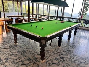 a pool table with balls on it in a room at Kalasita in Mahabaleshwar +70 photos