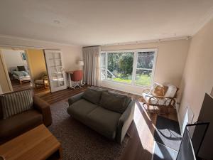 a living room with a couch and a table at Red Gum & Stone - Peace Space Nature in Warburton