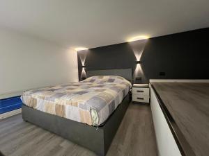a bedroom with a bed and two lights on the wall at Vista Mare in Cipressa