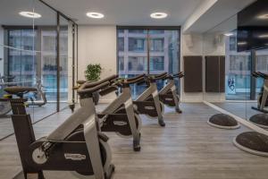 a row of treadmills in a gym with windows at INNSiDE by Meliá Newcastle in Newcastle upon Tyne
