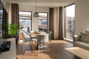 a living room with a table and chairs and a room with a view at INNSiDE by Meliá Newcastle in Newcastle upon Tyne