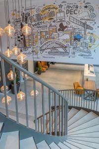 a staircase with a mural on the wall at INNSiDE by Meliá Newcastle in Newcastle upon Tyne