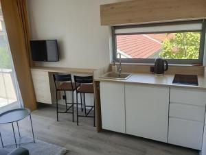a small kitchen with a sink and a window at M&D Appartments in Valtice