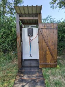 an open door with a gate and aperature at Hilltop Farm Camping in Haselbury Bryan