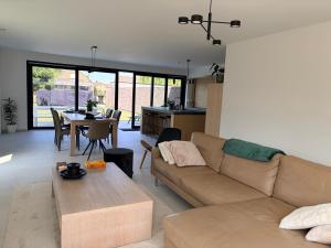 a living room with a couch and a table at Ten Zilte in Blankenberge