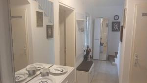 a white bathroom with a sink and a toilet at Apart SRDJ&MAR in Dobra Voda +58 photos