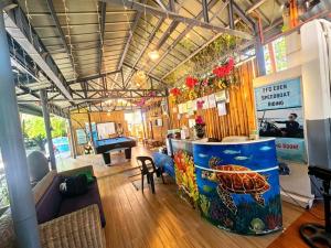 a living room with a table and a room with a turtle on it at FFG Eden Private Resort in Basdiot
