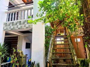 a staircase leading up to a house with plants at FFG Eden Private Resort in Basdiot
