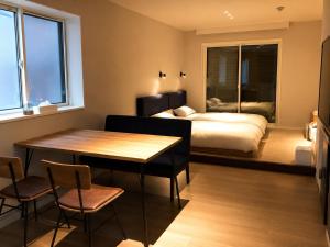 a bedroom with a bed and a table and chairs at 5 minutes Shin-Osaka 9 in Osaka