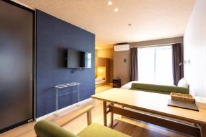 a living room with a table and a blue wall at 5 minutes Shin-Osaka 9 in Osaka