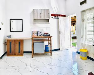 a kitchen with a wooden table and a desk at Himali Niwasa in Matara