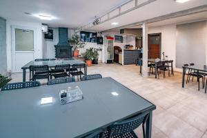 a large room with tables and chairs and a kitchen at Casa Dumitrescu in Năvodari +10 photos