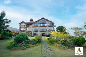 a large house with a garden in front of it at Marabedda Gardens Resort in Rikillagaskada