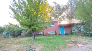 a tree in the yard of a house at Tree bedrooms in Salt Lake City