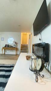a living room with a flat screen tv on a bed at Tree bedrooms in Salt Lake City +3 photos