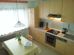 a kitchen with a table and a stove top oven at Ferienwohnung Taubertal Familie Arold in Creglingen