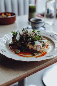 a plate of food sitting on a table at InPoint Smart Apartments in Krakow