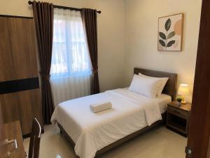 a bedroom with a bed with a tray on it at Terrace SSS Homes in Araguaína