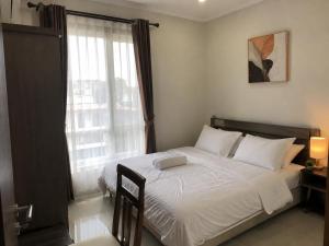 a bedroom with a bed and a large window at Terrace SSS Homes in Araguaína