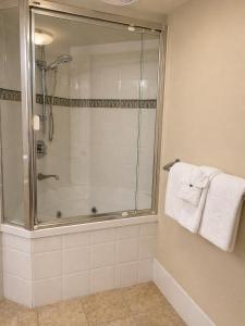 a bathroom with a shower with a glass door at Landmark Resort Mooloolaba 4th Floor Apartment with a View in Mooloolaba +10 photos