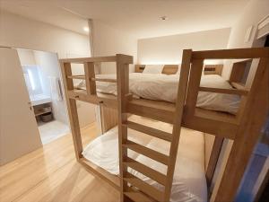 a bedroom with two bunk beds and a mirror at CONTEL BASE Tokyo in Tokyo