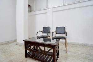 two chairs sitting on top of a table in a room at Hotel O Patel Nagar Patna Formerly Princess Home in Patna