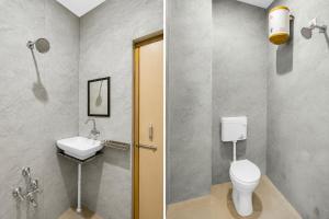 a bathroom with a toilet and a sink at Townhouse Defence Colony Noida in Greater Noida