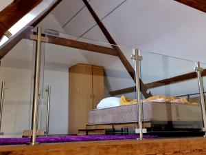 a bed in a room with a glass wall at Historic Canal-Side Apartment in Schiedam