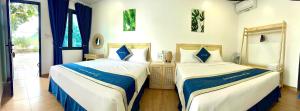 two beds sitting next to each other in a bedroom at Woodstock Beach Camp in Cat Ba +46 photos
