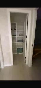 an open door to a white closet in a room at Panoramic view in Tamga