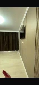 a room with a bed and a television in it at Panoramic view in Tamga