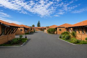 a row of houses with orange roofs and a driveway at Geraldton's Ocean West Holiday Units & Short Stay Accommodation in Geraldton