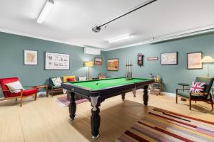 a room with a pool table and some chairs at 21 Forever in Pokolbin