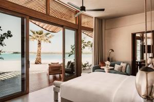 a bedroom with a bed and a view of the ocean at Miraval The Red Sea All Inclusive Adults Only in Ḩanak +222 photos