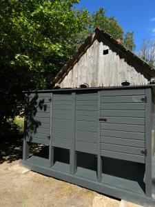 a wooden shed with a roof on top of it at Vaide kempings in Vaide