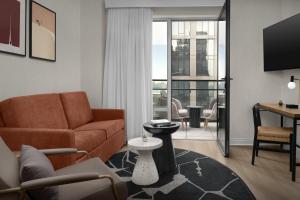 a living room with a couch and a table at The Livingston, part of JdV by Hyatt in Brooklyn
