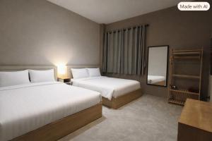 a hotel room with two beds and a mirror at Kosin House in Bangkok