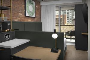 a room with a table and a clock on the wall at The Livingston, part of JdV by Hyatt in Brooklyn +65 photos