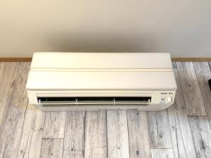 a air conditioner sitting on the floor in a room at 金森赤レンガ倉庫徒歩すぐ 伝統建築リノベ貸切 最大8名 最新設備 in Hakodate +42 photos