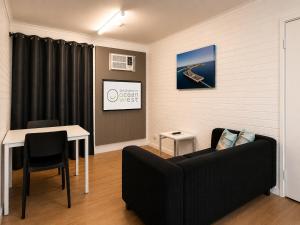 a living room with a couch and a table at Geraldton's Ocean West Holiday Units & Short Stay Accommodation in Geraldton