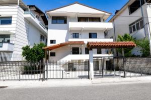 a fence in front of a white building at Villa Reve de Tirana in Tirana
