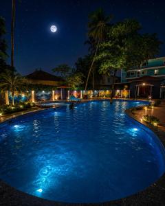a large swimming pool at night with a full moon at Beach Resort in 1 in North goa