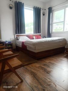 a bedroom with a bed and a large window at Virasat in Uttarkāshi