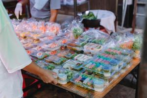 a person standing in front of a table of food at แพ River Tale Uthaithani in Ban Khok Mo +22 photos