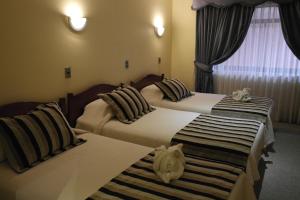 Hotel Royal Victoria tesisinde bir odada yatak veya yataklar