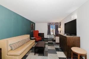 a living room with a couch and a flat screen tv at Wyndham Garden Texarkana in Texarkana