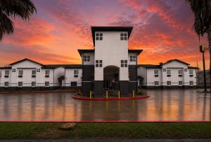 a building in the middle of a flooded street at Super 8 by Wyndham Brenham TX in Brenham