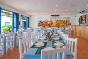 a dining room with a blue table and white chairs at Microtel by Wyndham Puerto Princesa in Puerto Princesa City