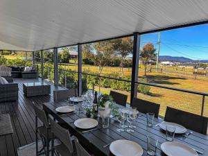 a table with wine glasses on top of a deck at Pebblebrook in Millfield