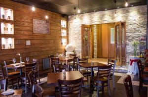 a restaurant with wooden walls and tables and chairs at Hotel Royal Victoria in Victoria